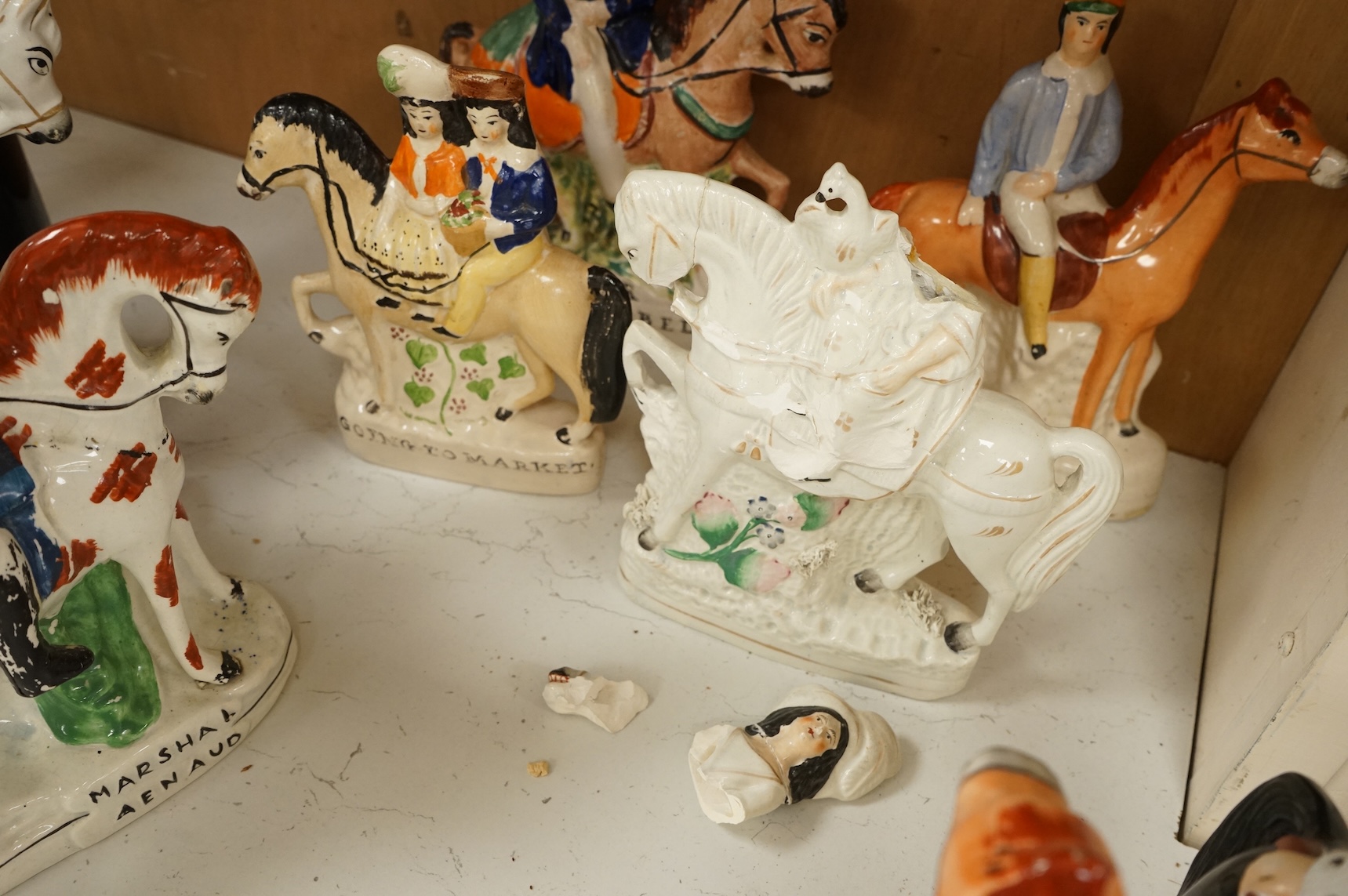 Thirteen Staffordshire pottery equestrian figures to include Tom King, Dick Turpin and Sir Colin Campbell, largest 28cm high